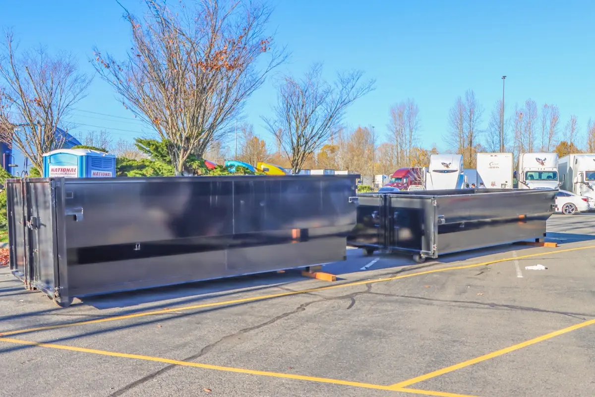 Professional dumpster rental service with roll-off container on residential driveway in Hebron